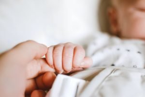 person holding baby s hand